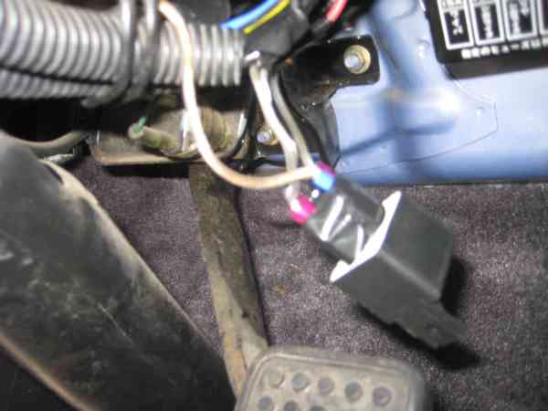 The relay as I saw it, dangling next to the gas pedal.  It was not attached to anything, I'm assuming they tucked it in with some of the other wires and it eventually wiggled loose.