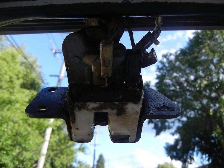 Latch hanging from door. it comes out this far after the rod clips have been taken off.