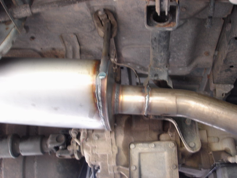 The muffler is tucked up there in the same spot as stock.