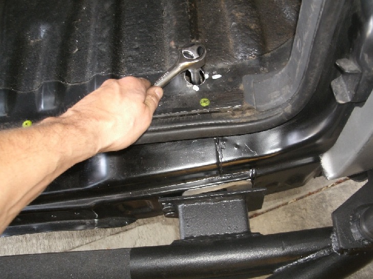 Drilled 1&quot; hole for socket access.  This also enables the use of 1&quot; long bolts directly on the frame rail.  Note that the front 3/8&quot; bolts will draw the bumper inside the apron before the vertical bolts are torqued.