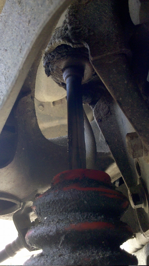 see, it looks pretty icky up at the top, and the passenger side shock boot is safe and secure. This one looks rotten in comparison