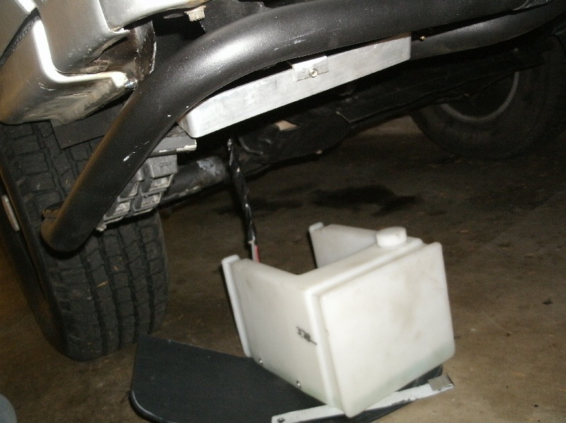 The whole thing simply slides out onto the ground for refilling...no messes to worry about.
