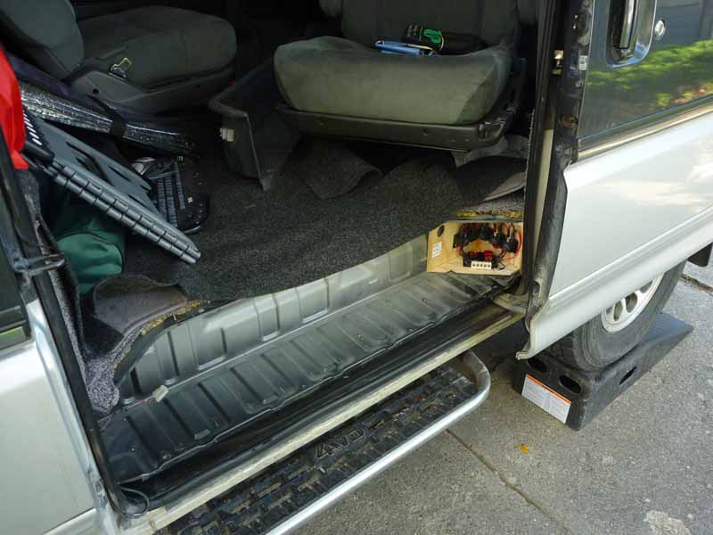 Step with plastic cover removed. Relays for the rear lights in the corner.