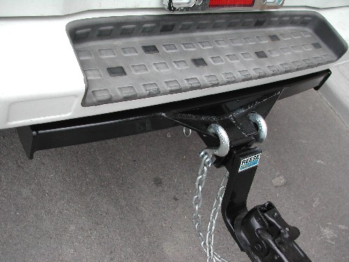 I got this hitch built for my van by a local welder.  He does metal staircases, railing, etc. so mine has a spreader that is curved to match the curve of the rear bumper.  I really like the looks of it.  Cost me $400.  Wired the trailer lights myself.
