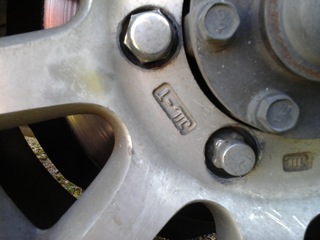closeup of the weird lug nut compared to a normal one