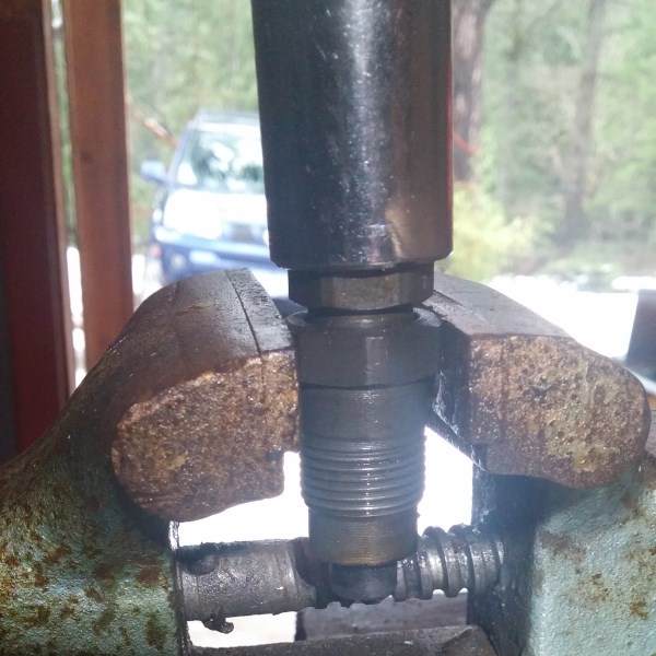 Support the injector body in a vice and using a 17mm socket, crack the body.