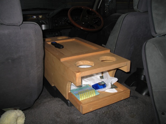 My console, looking forward. Open compartment on rear edge, cupholders for the rear passengers.