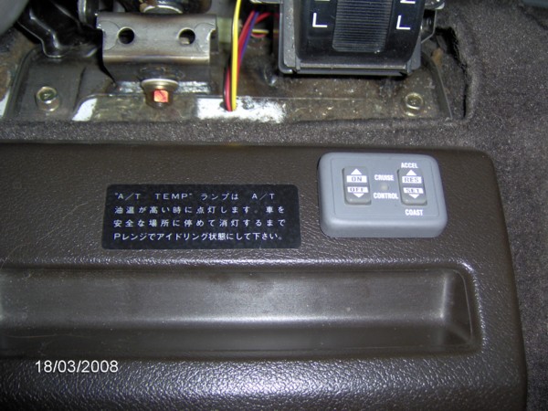 I mounted the controller right behind the shifter.  Easy access and easy to see.  Cabling is routed under the console and enters the engine compartment close to the hinge at the back.  The cabling you can see between the shifters are the lines going to the brake pedal, park lights and power.