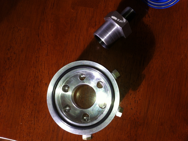 The seal that goes against the engine side. Note the side ports I requested to be drilled in are the brass bolts.