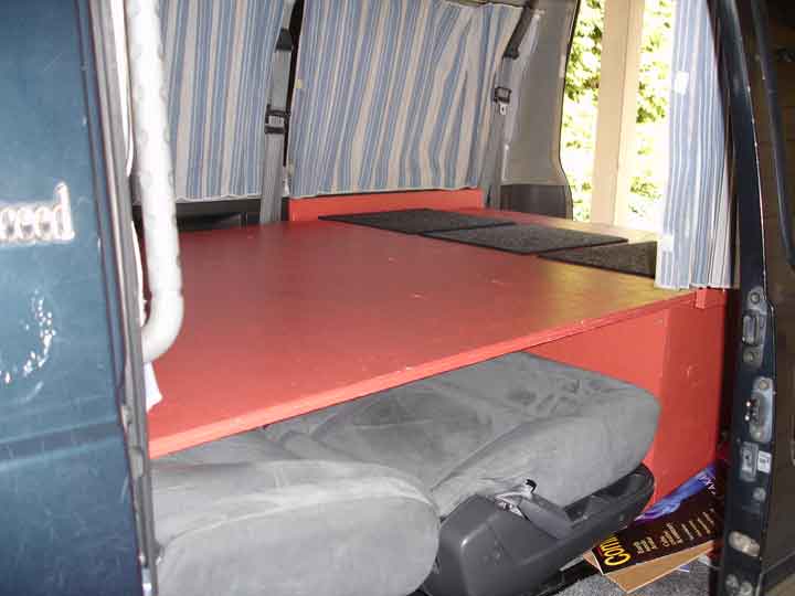 bed extended over captains chairs.